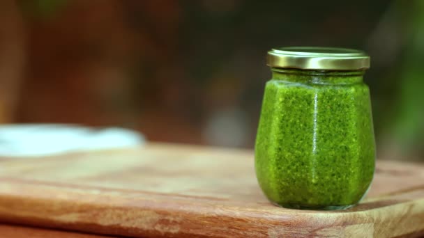 Natural herb jar. Pesto sauce. Color background. - Footage, Video