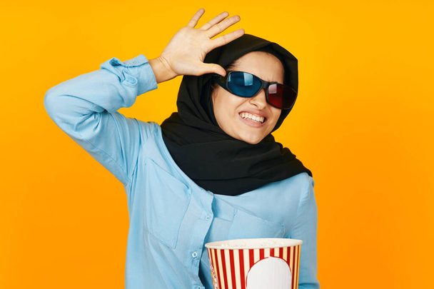pretty woman 3D glasses watching movies in the cinema yellow background - Fotó, kép