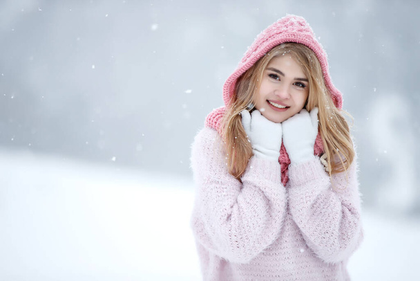 Winter woman in the snow. Beautiful girl in the winter in nature. - Photo, Image