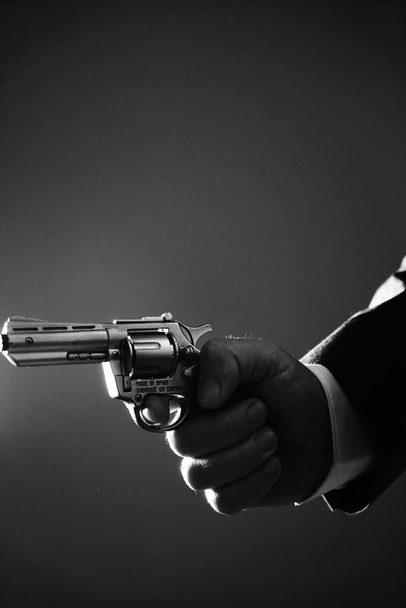 Retro secret agent with pistol revolver gun in hand in vintage crime thriller mockup cover     photo.        - Zdjęcie, obraz