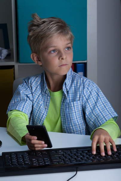 Young boy with phone and computer - Fotoğraf, Görsel