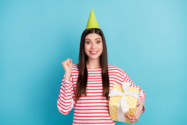 Portrait of attractive girlish cheerful girl holding gift having fun rest cool event isolated over bright blue color background - Fotografie, Obrázek