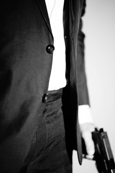 Detective male spy holding pistol gun crime thriller book cover design photo. - Photo, image