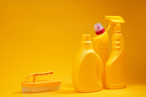 House cleaning detergent bottles on a yellow background - Фото, изображение