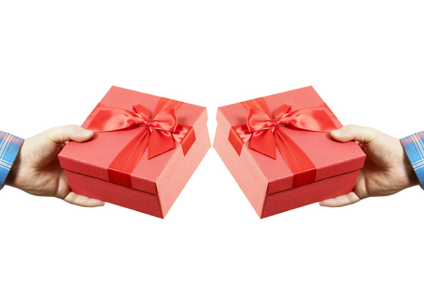 Male hand holding a red gift box on an isolated background. Mirror image - Photo, Image