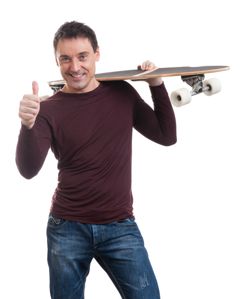 Happy smiling man holding longboard in his hand - Фото, зображення