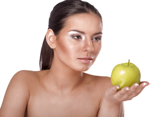 Young woman eating green apple isolated over white background - Fotoğraf, Görsel