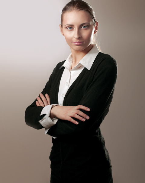 Portrait of beautiful business woman standing with folded arms, isolated on grey - Foto, Imagem