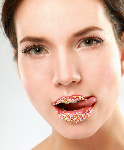 Woman lips with multicolored pearls - 写真・画像