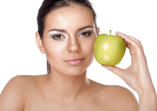 Young beautiful woman eating green apple isolated over white - Fotografie, Obrázek