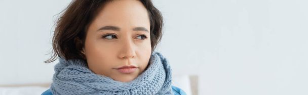 young woman in knitted scarf looking away, banner - Фото, зображення