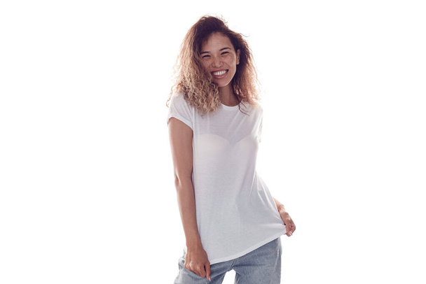 Attractive woman with lush curly hair in white blank t-shirt isolated on white background. Mock-up. - Foto, afbeelding