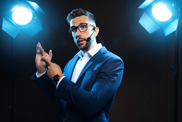 Motivational speaker with headset performing on stage - Foto, immagini