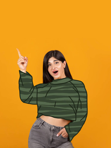 Contemporary art collage of beautiful excited young woman wearing green drawn sweater isolated over orange background. Concept of winter holiday - Fotografie, Obrázek