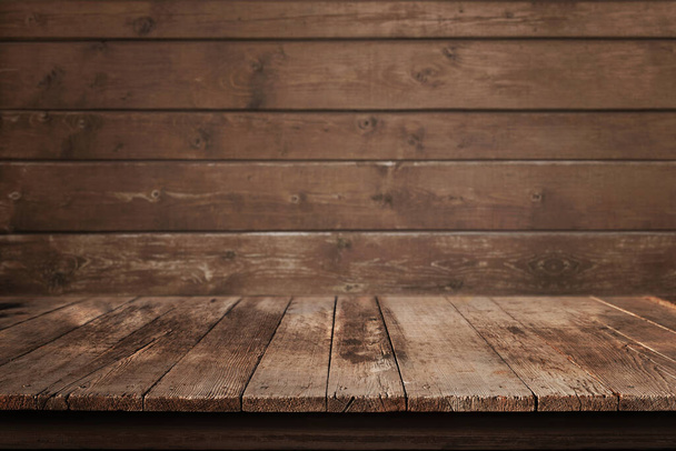 Clean wooden desk for product, design promotion. Wooden wall in background - Фото, изображение