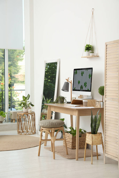 Stylish room interior with comfortable workplace. Home office - Фото, зображення