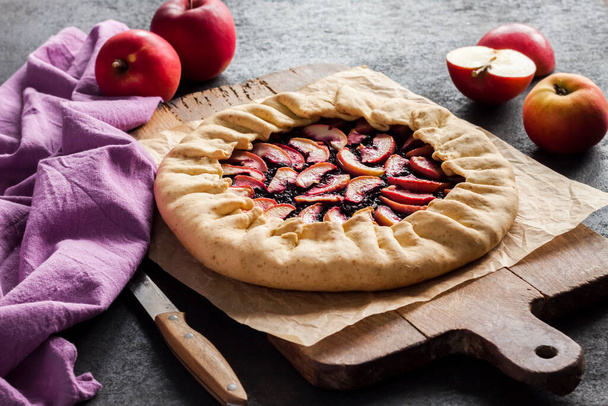 Lenten sweet galette with apples and elder berries on woden board - Photo, image