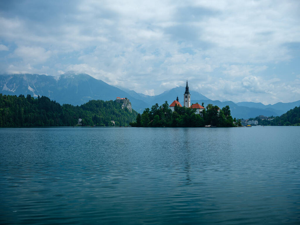 Church on island in lake Bled, Slovenia. Summer day with clean water - Photo, Image