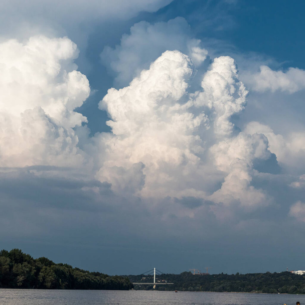 A mesmerizing view of the cloudscape over the bridge and Danube river in Novi Sad Serbia - Fotoğraf, Görsel