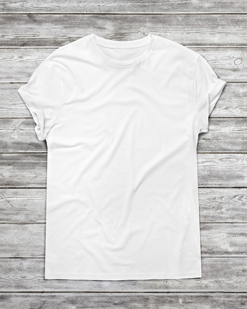 White t-shirt on wood wall - Фото, зображення