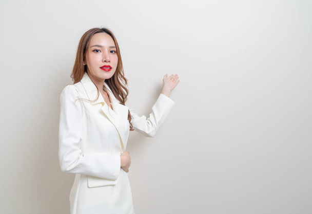 portrait beautiful Asian business woman with hand presenting or pointing on white background - Zdjęcie, obraz
