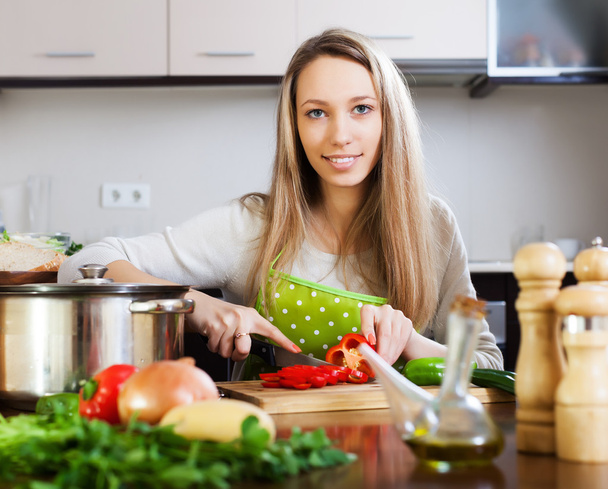 Smiling  housewife cooking with vegetables   - Fotó, kép