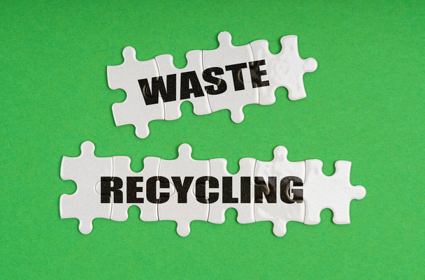 Environmental concept. On a green background, there are puzzles on which it is written - waste recycling - Φωτογραφία, εικόνα