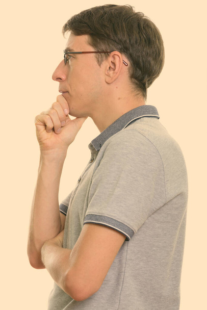 Studio shot of skinny man with short hair isolated against white background - Photo, Image