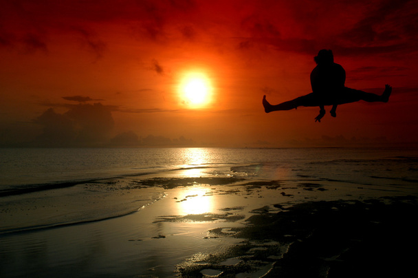 Silhouette of a man jumping with sunrise baground - Photo, Image