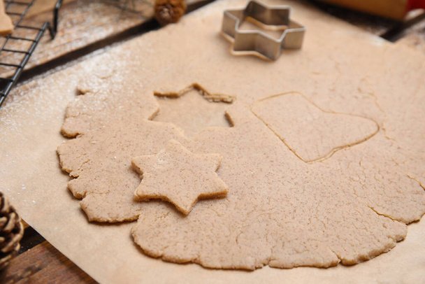 Homemade Christmas biscuits. Dough and cookie cutter on table, closeup - Fotografie, Obrázek