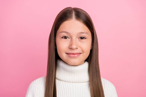 Portrait of attractive cheery content brown-haired preteen girl wearing warm jumper isolated over pink pastel color background - Фото, изображение