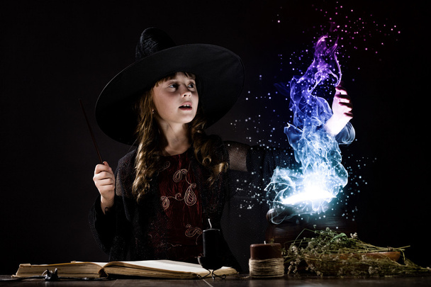 Little witch reading conjure - Foto, imagen