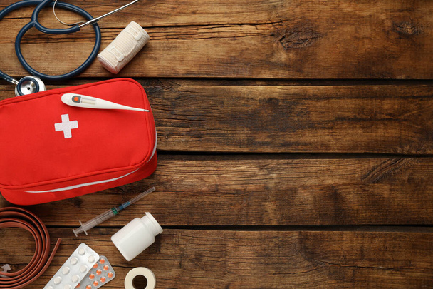 First aid kit on wooden table, flat lay. Space for text - Fotoğraf, Görsel