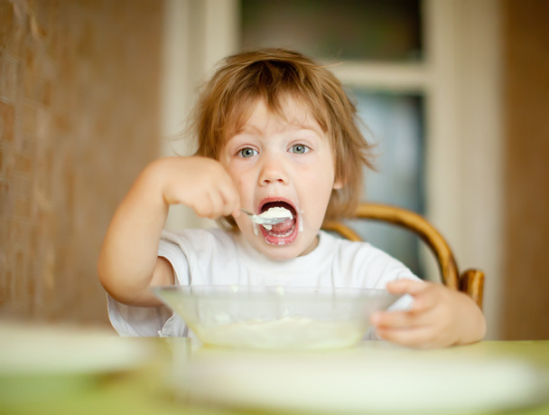  child eats dairy  with spoon - Photo, image