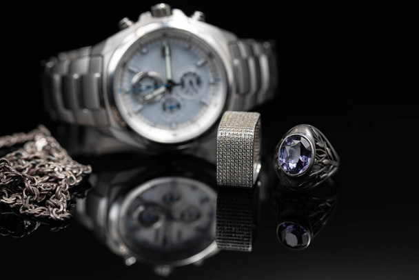 Men's watches in titanium case and women's jewelry made of silver - Photo, Image
