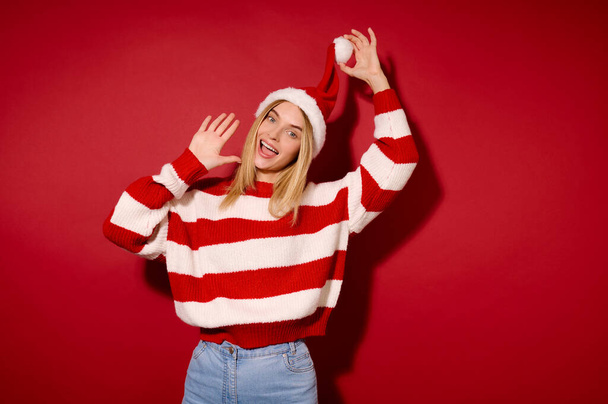 A blonde young girl in a red and white clothes - Photo, image