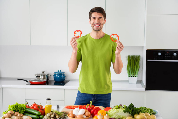 Portrait of attractive cheerful guy cooking meal having fun homemade restaurant at home kitchen indoors - Фото, зображення