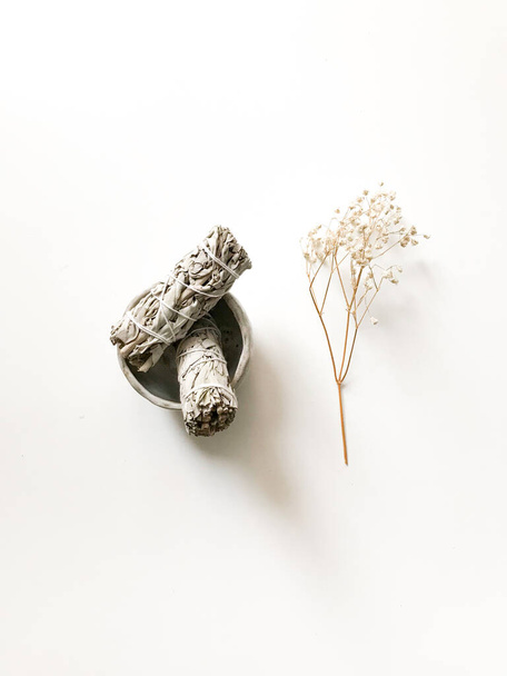 bunches of white California sage on a white background, minimalism and a place for text. sacred incense, aromatherapy and meditation - 写真・画像