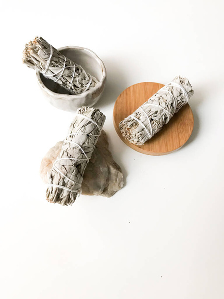 bunches of white California sage on a white background, minimalism and a place for text. sacred incense, aromatherapy and meditation - Valokuva, kuva