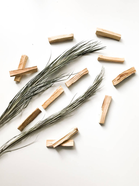 a set of palo santo sticks, a square frame, a place for text. aroma background on a white background with light blurred - Fotó, kép