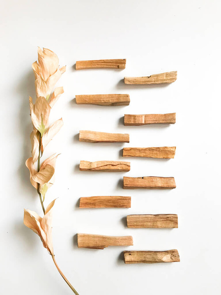 a very beautiful background of wooden palo santo sticks, aromatherapy and the magic of aromas on a white background. Light image blurring, lack of focus, soft texture combinations. - Photo, Image