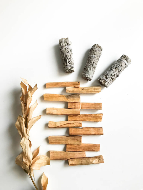 beautiful layout of palo santo and white sage, aromatherapy and incense on a white background. Place for text, religious minimalistic background - Fotografie, Obrázek