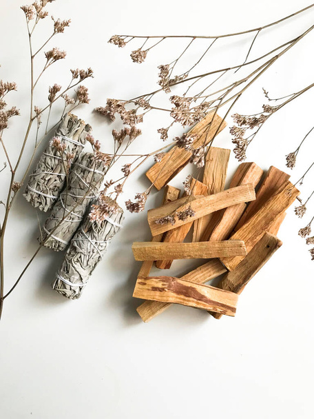 beautiful layout of palo santo and white sage, aromatherapy and incense on a white background. Place for text, religious minimalistic background - Foto, Bild