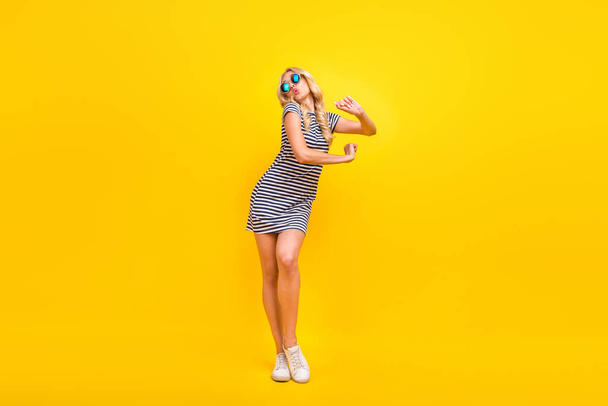 Full length body size photo woman wearing sunglass dress chilling at party on weekend isolated vibrant yellow color background - Foto, Bild
