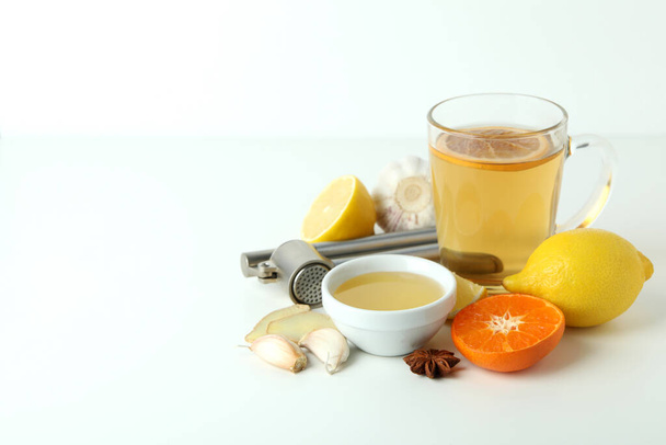 Concept of treatment colds with honey and garlic on white background - Photo, Image