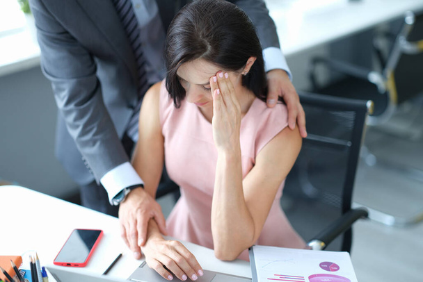 Businessman pestering female colleague in the workplace. - Photo, Image
