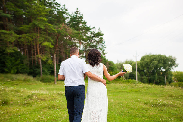 bride and groom are going to the forest - Photo, image
