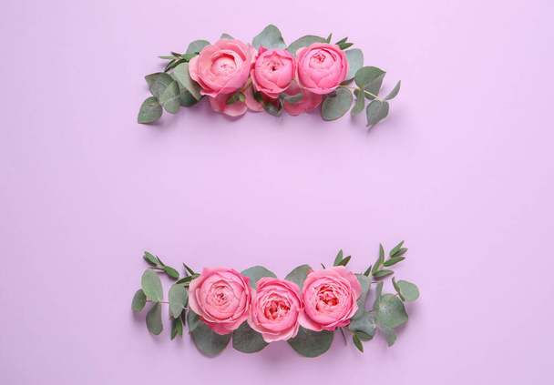 Wreathes made of beautiful flowers and green leaves on violet background, flat lay. Space for text - Valokuva, kuva