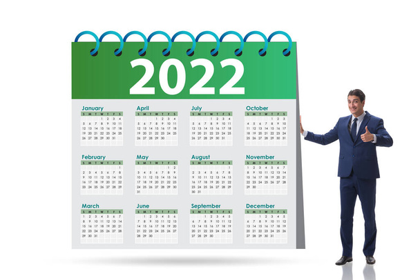 Uomo d'affari nel concetto di calendario dell'anno 2022 - Foto, immagini