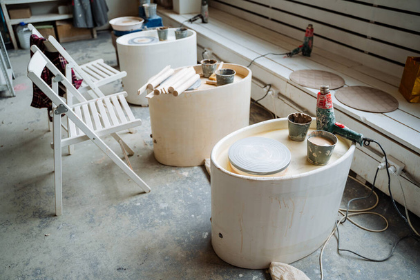 Photo of the interior in the pottery workshop, the place of work of the masters. Everywhere there is equipment for creating ceramic dishes. High quality photo - 写真・画像